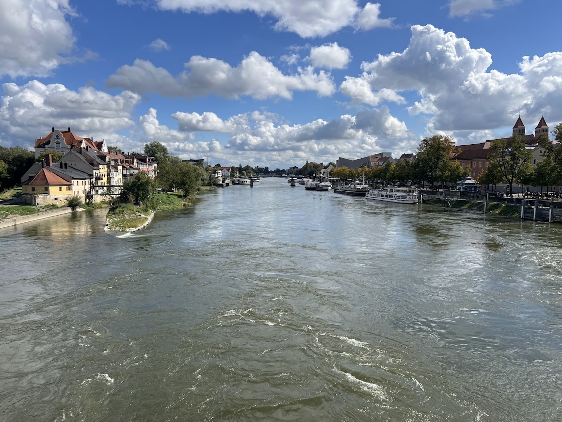 The Danube running through Regensburg, Germany on a beautiful fall day. Blue sky with puffy white clouds.