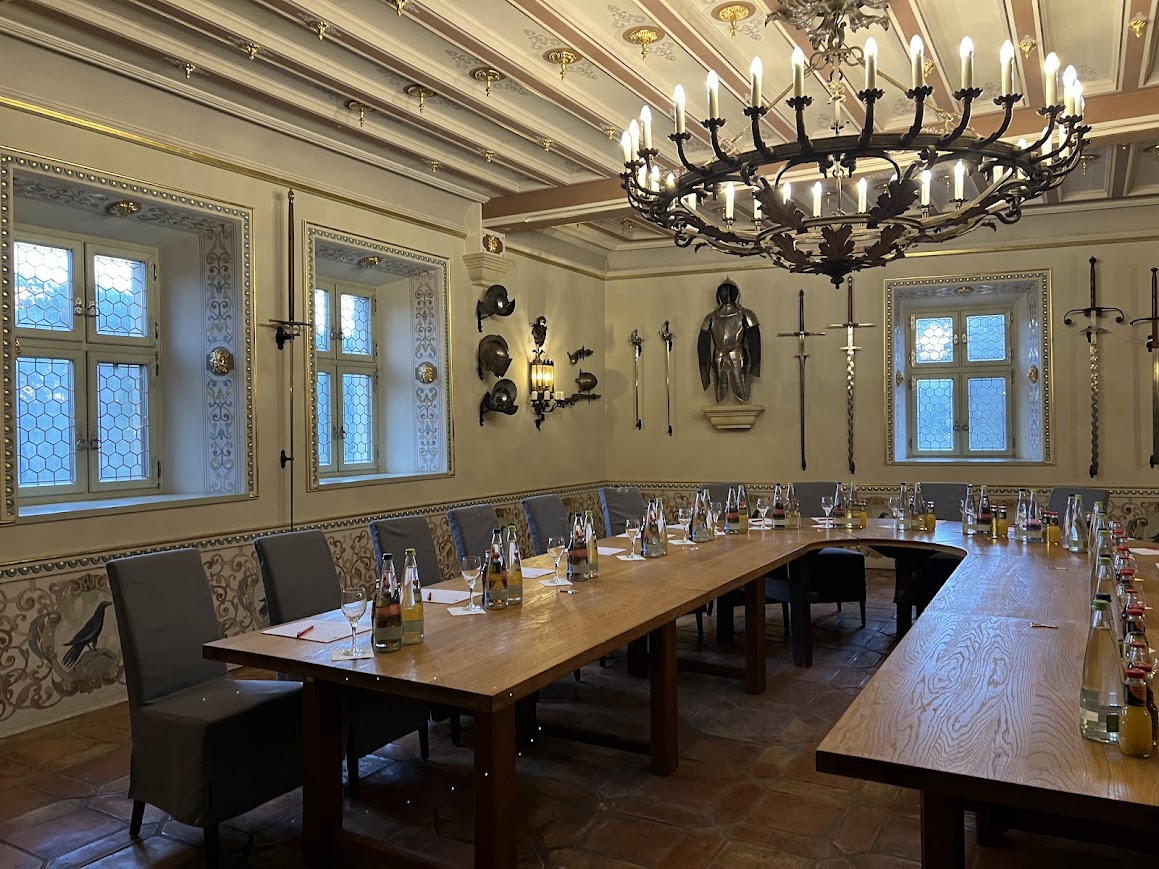 An ornate room now used for conferences in a castle in Germany.