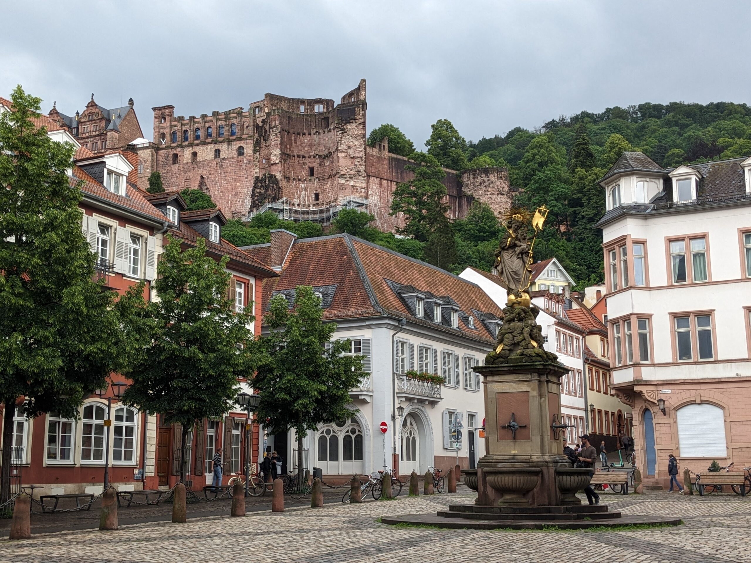 View of Heidelberg Castle overlooking the city's charming town square with classic architecture in Baden-Württemberg.