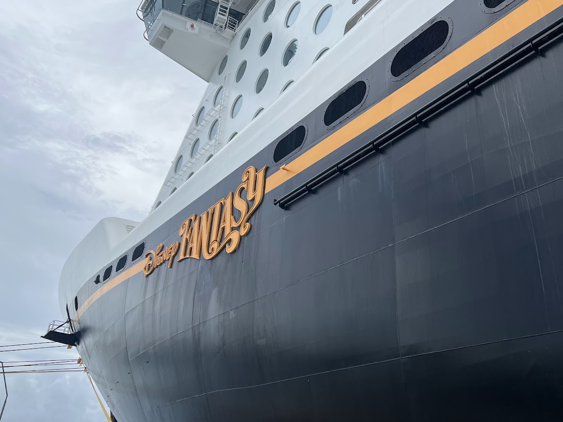 Close-up of the Disney Cruise Line's the Fantasy's name plate on an overcast day.